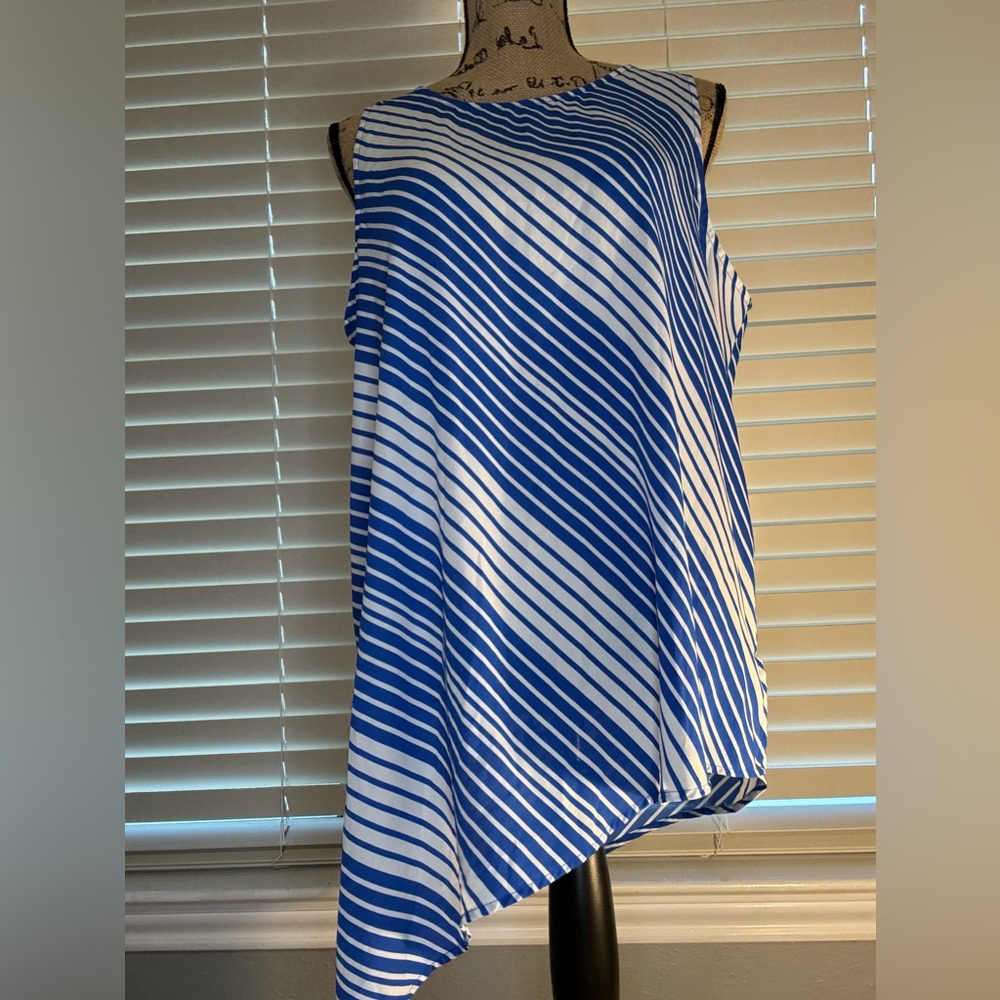 Vince Camuto ~ Blue and White Striped Sleevless Shirt. Bottom is an angle cut.